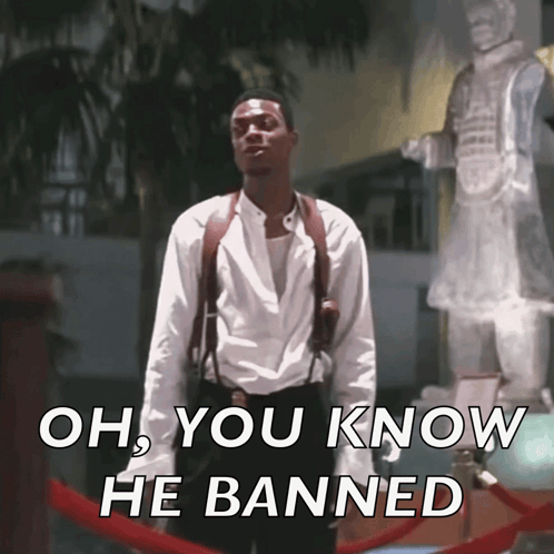 A Man Standing In Front Of A Statue With The Words Oh You Know He Banned On The Bottom GIF