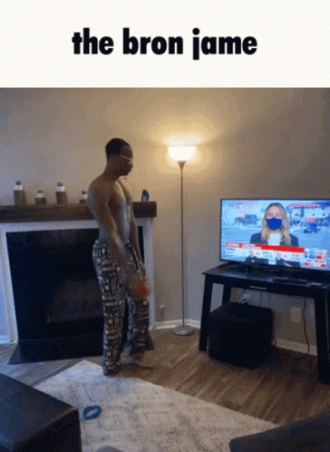 A Man Standing In Front Of A Television With The Words The Bron Jamie On The Bottom GIF