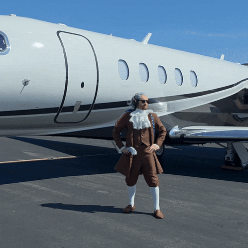 A Man Standing In Front Of A White Airplane GIF