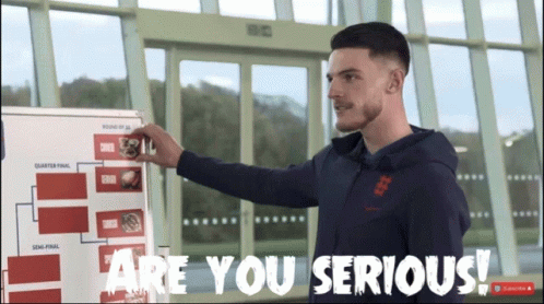 A Man Standing In Front Of A White Board That Says Are You Serious GIF