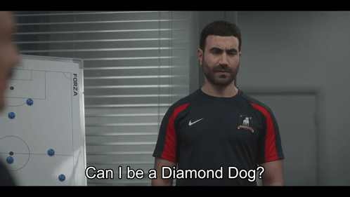 A Man Standing In Front Of A White Board With The Words Can I Be A Diamond Dog GIF