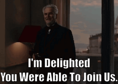 A Man Standing In Front Of A Window With The Words " I 'M Delighted You Were Able To Join Us " Written Below GIF