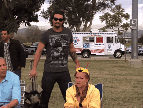 A Man Standing In Front Of An Ice Cream Truck That Says Ice Cream GIF