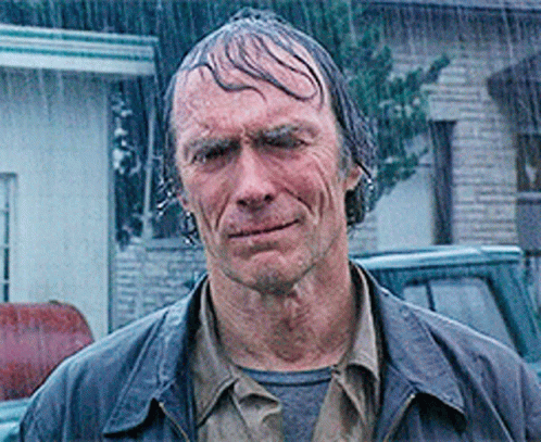 A Man Standing In The Rain With Wet Hair GIF