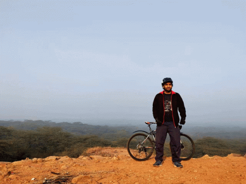 A Man Standing Next To A Bike Wearing A Shirt That Says ' I Love Cycling ' On It GIF
