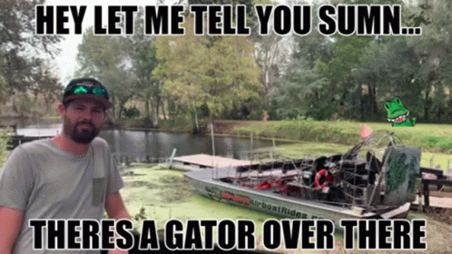 a man standing next to a boat that says airboat rides on the side