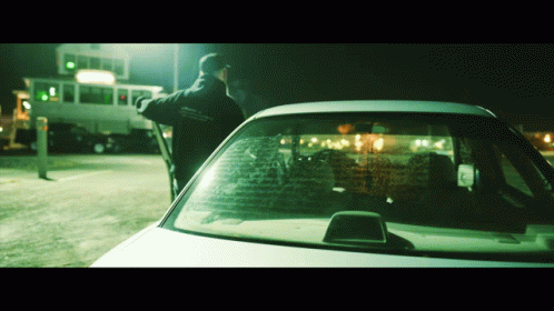 A Man Standing Next To A Car That Has A Sticker On The Windshield That Says ' Ambulance ' GIF