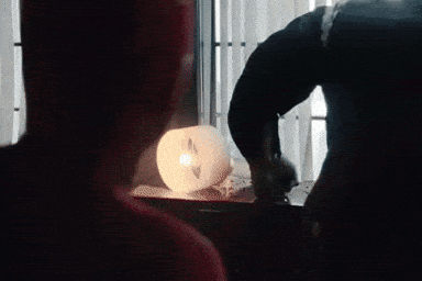 A Man Standing Next To A Giant Monster In A Room GIF