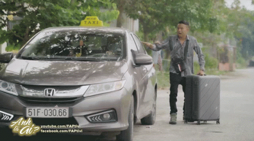 A Man Standing Next To A Honda Car With A Taxi Sign On The Top GIF