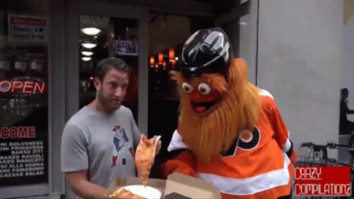 A Man Standing Next To A Mascot Holding A Pizza In Front Of A Store That Says Open GIF