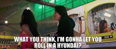 A Man Standing Next To A Woman With The Words What You Think I 'M Gonna Let You Roll In A Hyundai ? GIF