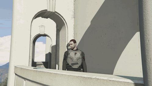 A Man Standing On A Balcony In Front Of A Building GIF
