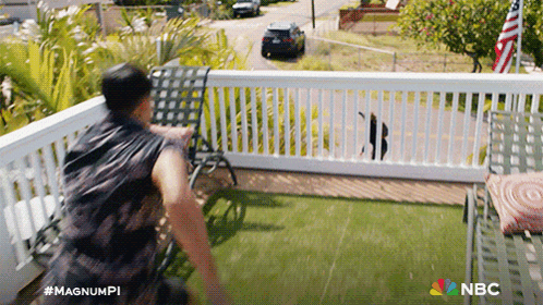 A Man Standing On A Balcony With The Nbc Logo On The Bottom Right GIF
