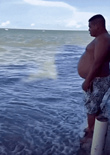 Man Standing On Dock Looking At Ocean GIF