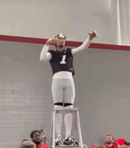 A Man Standing On A Ladder With The Number 7 On His Jersey GIF