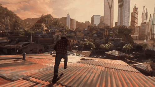 A Man Standing On A Rooftop Looking Out Over A City GIF