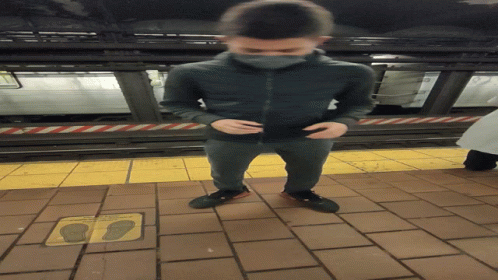 A Man Standing On A Tiled Floor Next To A Sign That Says " Do Not Walk On The Sidewalk " GIF