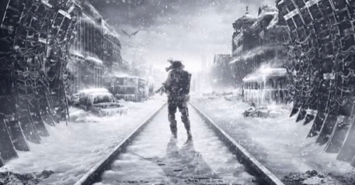 A Man Standing On A Train Track In The Snow GIF