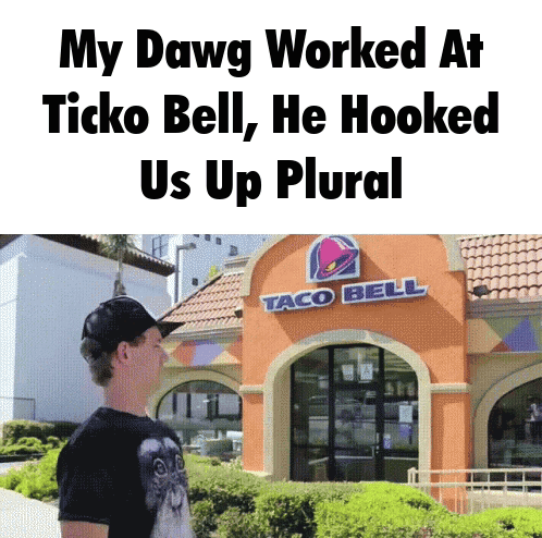 A Man Standing Outside Of A Taco Bell Restaurant GIF