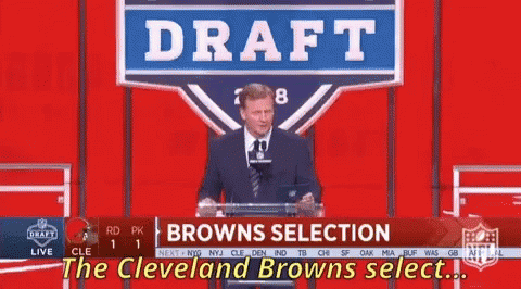 a man stands at a podium with a sign that says draft browns selection