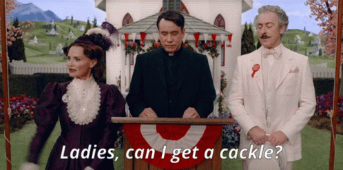 A Man Stands At A Podium With The Words Ladies Can I Get A Cackle Behind Him GIF