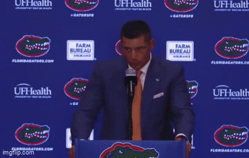 a man stands at a podium with the words well i don 't hire my friends behind him