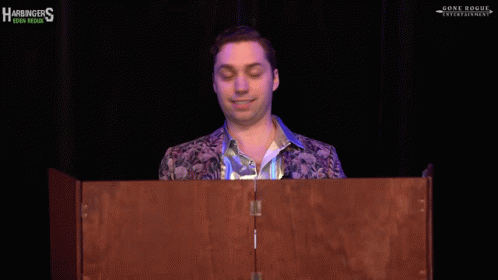 A Man Stands Behind A Podium That Says Just Wow On It GIF