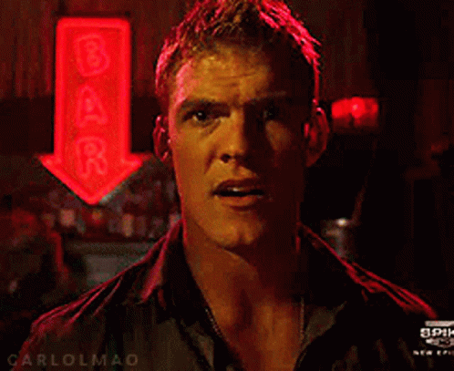 A Man Stands In Front Of A Bar Sign GIF