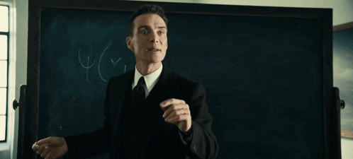 A Man Stands In Front Of A Blackboard With The Words It 'S Paradoxical And Yet It Works GIF