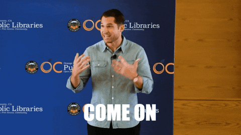 A Man Stands In Front Of A Blue Backdrop That Says Come On GIF