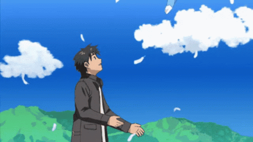 A Man Stands In Front Of A Blue Sky With Clouds GIF