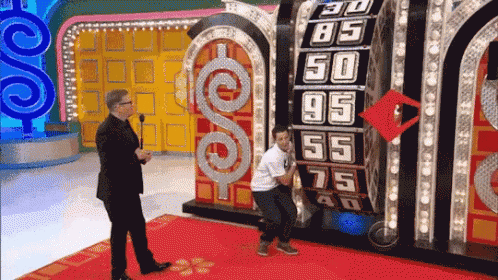 A Man Stands In Front Of A Board That Says 30 85 50 95 55 75 And 40 GIF