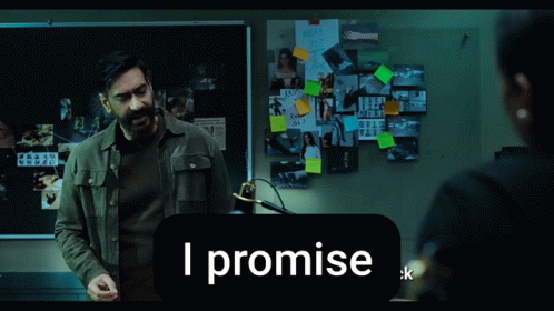 A Man Stands In Front Of A Bulletin Board That Says I Promise On It GIF
