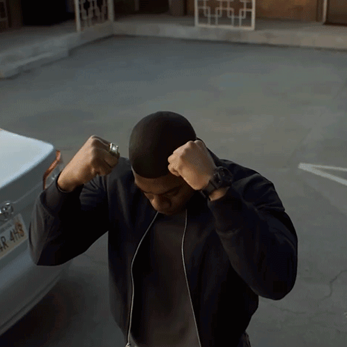 a man stands in front of a car with a license plate that says r 4h9