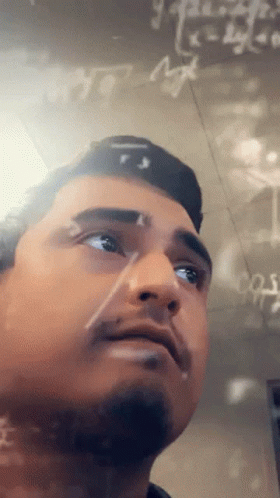 A Man Stands In Front Of A Chalkboard With Math Equations Written On It GIF
