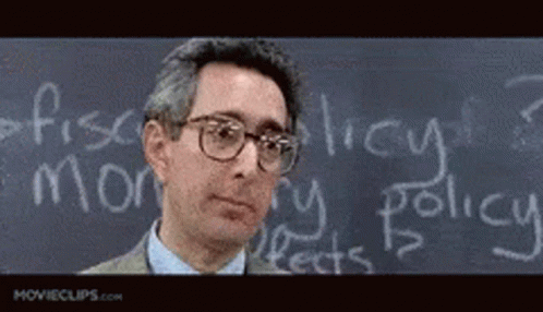 A Man Stands In Front Of A Chalkboard With The Word Policy Written On It GIF