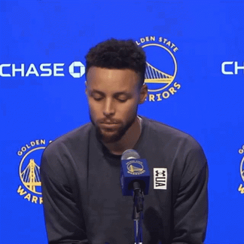 A Man Stands In Front Of A Chase Sign GIF
