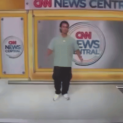 A Man Stands In Front Of A Cnn News Central Sign GIF