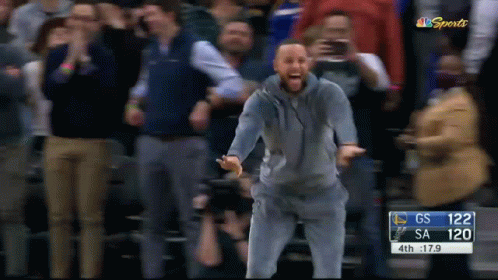 A Man Stands In Front Of A Crowd At A Basketball Game With A Score Of 120 To Gs GIF