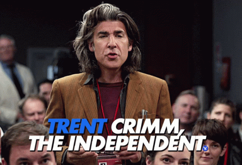 A Man Stands In Front Of A Crowd With The Words Trent Crimm The Independent Written Below Him GIF