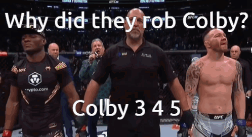 A Man Stands In Front Of A Crowd With The Words Why Did They Rob Colby On The Bottom GIF