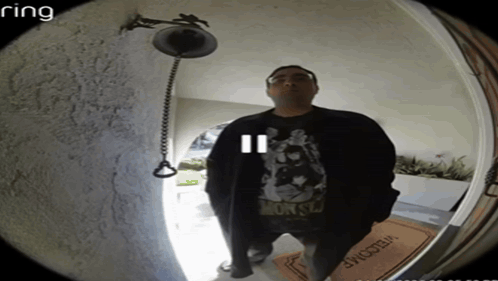 A Man Stands In Front Of A Door With A Welcome Mat GIF