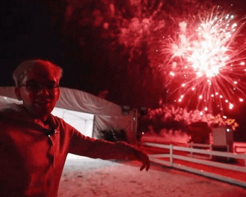 a man stands in front of a firework display