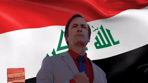 A Man Stands In Front Of A Flag That Says Allah GIF