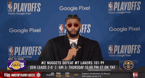 A Man Stands In Front Of A Google Pixel Banner During The Nba Playoffs GIF