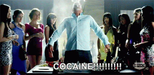 A Man Stands In Front Of A Group Of Women With The Words Cocaine Written On The Screen GIF