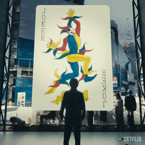 A Man Stands In Front Of A Joker Card GIF