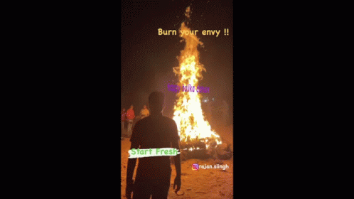 A Man Stands In Front Of A Large Fire With The Words Burn Your Envy On It GIF