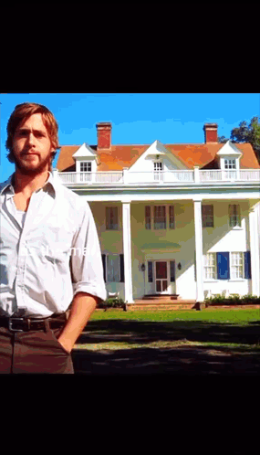 A Man Stands In Front Of A Large White House With His Hands In His Pockets GIF