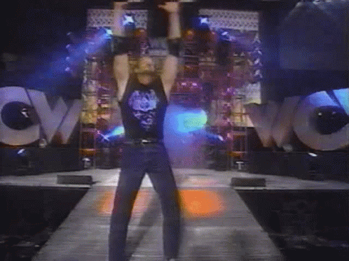 A Man Stands In Front Of A Large Wow Sign GIF